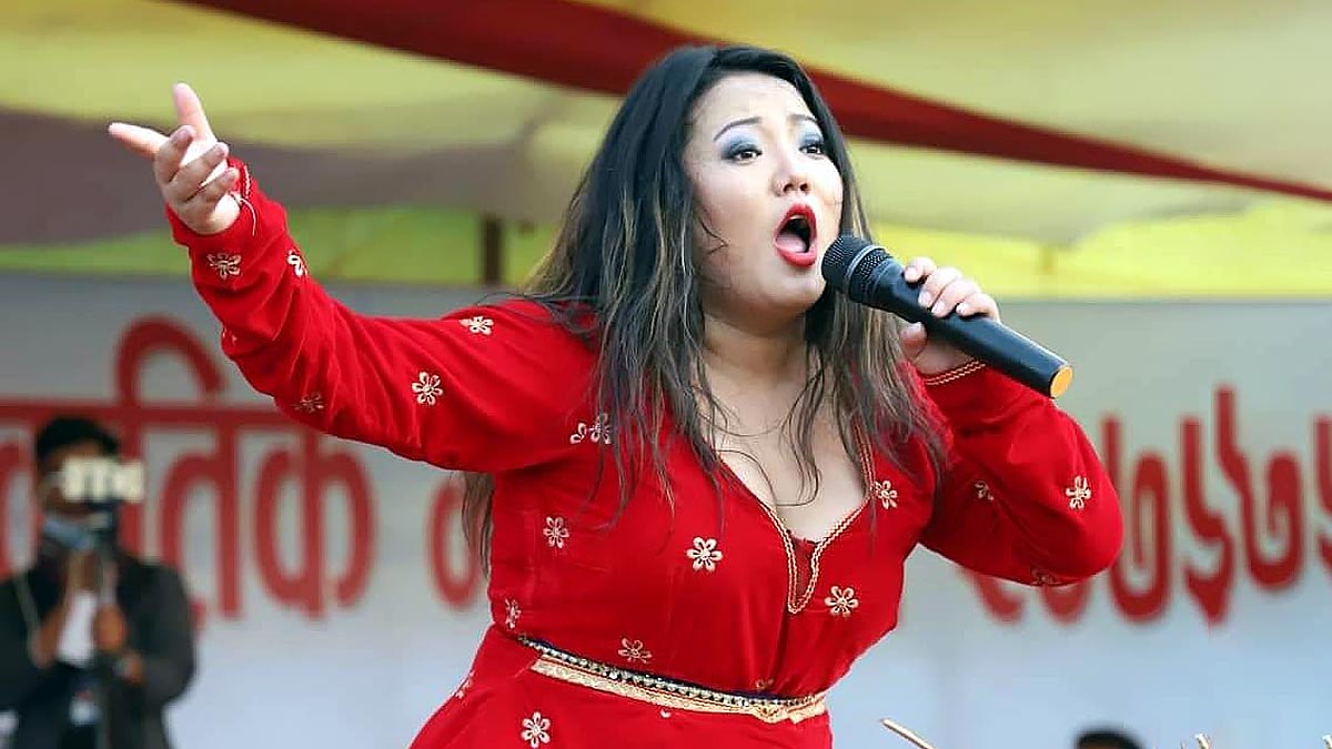 Singer Jyoti Magar performing live in stage wearing red dress