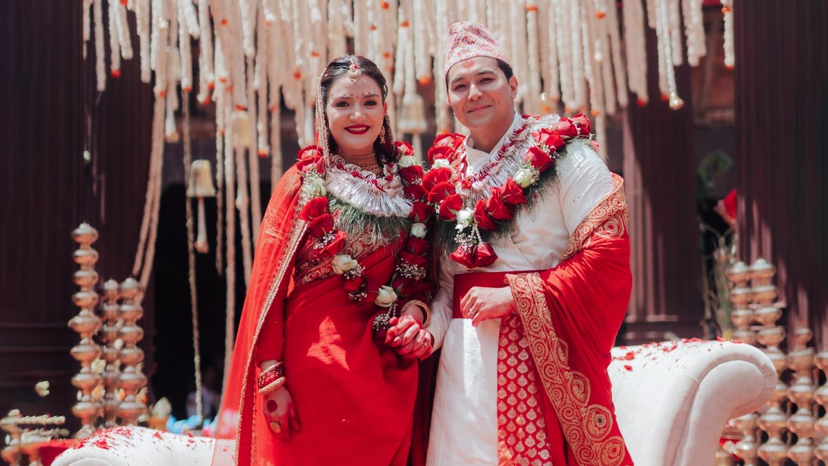 Subekshya Khadka and Ashwasan Joshi posing in traditional Nepali wedding attire with garlands at their wedding ceremony