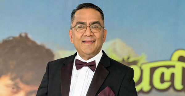 Dr. Kapil Rijal with a blurred Gauthali movie poster in the background.