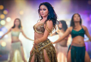 Eva Giri dances in a gold-embellished outfit with background dancers under colourful lights in Panch Pandav’s song “Raja Chahiya Chha.”